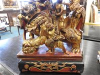 Lot 145 - Two Chinese painted carved hardwood temple lions