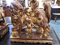 Lot 145 - Two Chinese painted carved hardwood temple lions