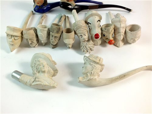 Lot 88 - Fourteen standard figural clay pipes