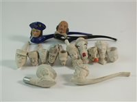 Lot 88 - Fourteen standard figural clay pipes