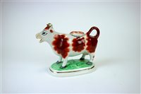 Lot 109 - A Staffordshire cow creamer and cover