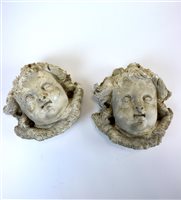 Lot 107 - A decorative pair of cast simulated limestone roundels