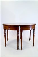 Lot 386 - A pair of regency mahogany dining table D ends