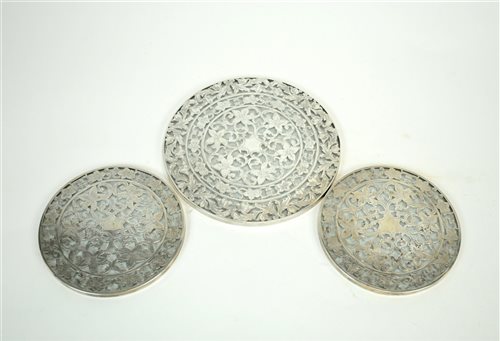 Lot 141 - Three white metal mounted glass coasters