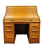 Lot 360 - An early 20th century varnished mid-oak roll top pedestal desk