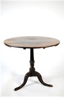 Lot 381 - A George III oak snap top tripod table