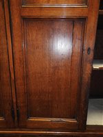 Lot 547 - A Regency oak and ebony strung house keeper’s cupboard