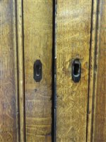 Lot 547 - A Regency oak and ebony strung house keeper’s cupboard