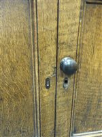 Lot 547 - A Regency oak and ebony strung house keeper’s cupboard