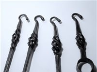 Lot 495 - A four piece wrought iron fireside companion set