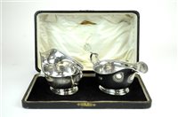 Lot 15 - Two cased sets of silver sauce boats and plated cruets