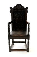 Lot 583 - A joined oak open armchair