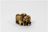 Lot 312 - A Japanese carved ivory okimono of a shishi