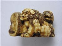 Lot 312 - A Japanese carved ivory okimono of a shishi