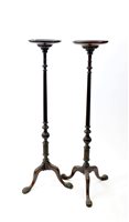 Lot 543 - A pair of George III style mahogany torchere stands