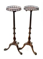 Lot 213 - A near pair of George III style mahogany torchere stands