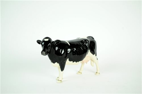 Lot 131 - A Beswick Friesian cow and calf together with Beswick Shetland Cow (3)