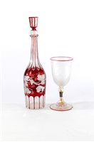 Lot 98 - A cranberry glass decanter and a wine goblet decorated with frosted cherubs