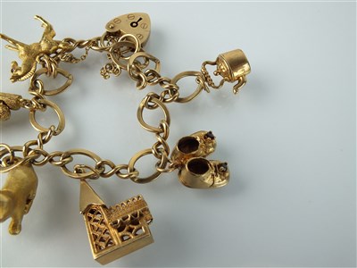 Lot 164 - A 9ct gold charm bracelet