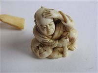 Lot 217 - A Japanese carved ivory okimono of a man with a noh mask