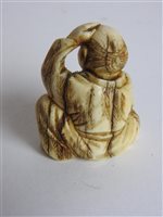 Lot 217 - A Japanese carved ivory okimono of a man with a noh mask