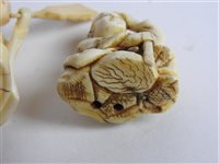 Lot 217 - A Japanese carved ivory okimono of a man with a noh mask