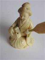 Lot 217 - A Japanese carved ivory okimono of a man with a noh mask