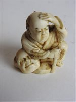 Lot 217 - A Japanese carved ivory okimono of a man with a noh mask