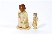 Lot 220 - A Japanese carved and stained bone okimono of a geisha