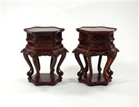 Lot 774 - A reproduction pair of Chinese carved and stained burr wood jardinière stands