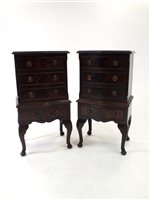 Lot 777 - A pair of reproduction serpentine fronted mahogany chest of four long drawers