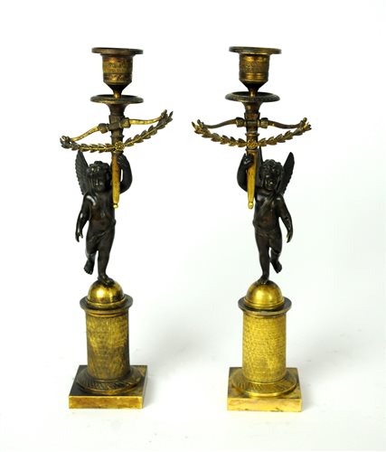 Lot 187 - A pair of early 19th century Empire bronze and gilt candlesticks