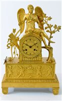 Lot 478 - A French Empire style gilt bronze figural mantel clock