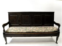 Lot 533 - A George III oak settle