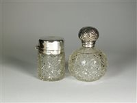 Lot 400 - Two silver topped glass dressing table bottles