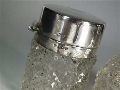 Lot 400 - Two silver topped glass dressing table bottles