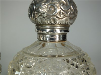 Lot 400 - Two silver topped glass dressing table bottles
