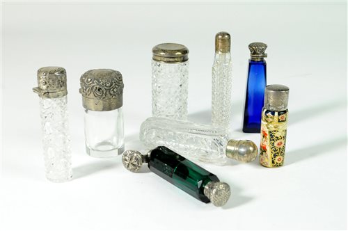 Lot 24 - A collection of silver topped scent bottles