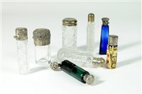 Lot 24 - A collection of silver topped scent bottles
