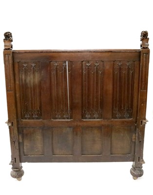 Lot 232 - A large carved oak bed frame in the Old English style