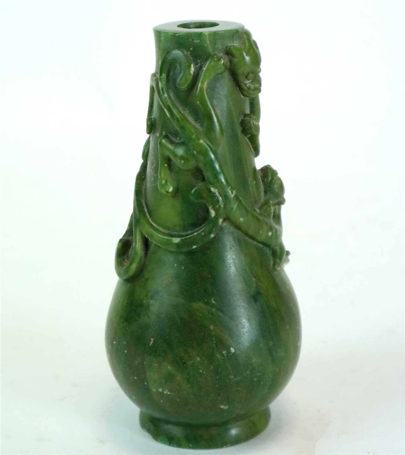 Lot 329 - A Chinese carved streaked green nephrite vase