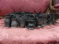 Lot 140 - A large collection of 22 pewter drinking vessels, mugs, measures etc