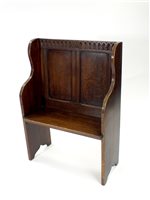 Lot 711 - A stained old English style oak settle of small proportions