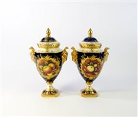 Lot 360 - A pair of Coalport fruit-painted vases and covers