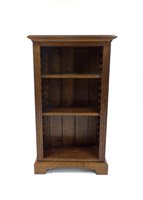 Lot 712 - A reproduction stained oak bookcase with small proportions