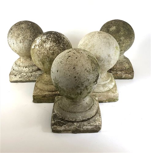 Lot 569 - Architectural salvage, a weathered set of five composite limestone knop finials