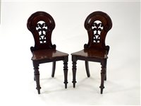 Lot 806 - A pair of Victorian carved mahogany hall chairs