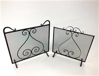 Lot 755 - Two wrought iron framed wire panelled fire guards