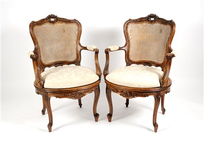 Lot 707 - A pair of French carved walnut framed bergere armchairs