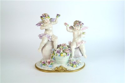 Lot 399 - A large Capodimonte group of two putti seated on barrels